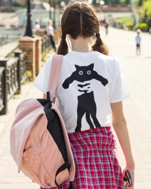 model wearing white t-shirt with black cat design